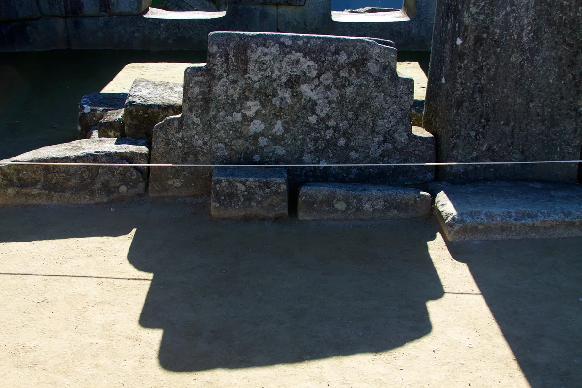 Chakana, the sacred Andean cross, carved in stone at Machu Picchu with the moon in the background — the first pair I learned to recognize